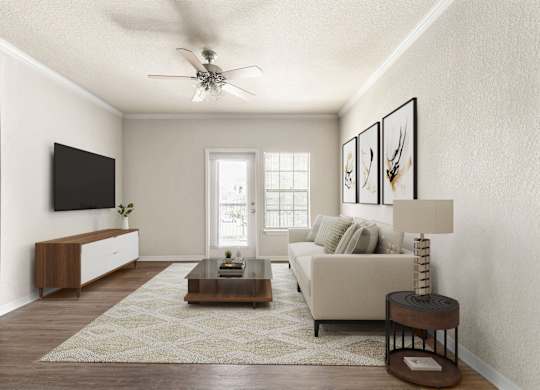 A living room with a white couch, a coffee table, and a ceiling fan.