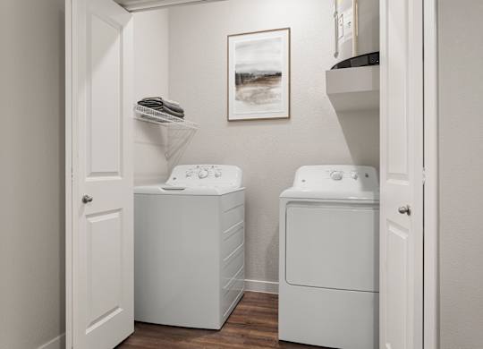 A small laundry room with a washer and dryer.
