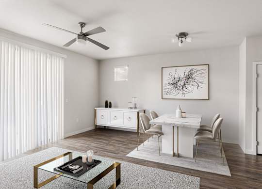 A modern dining room with a glass coffee table and white chairs.