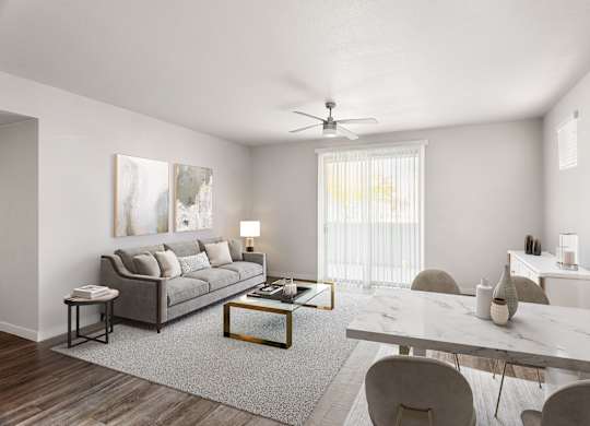 A modern living room with a grey sofa, a white coffee table, and a grey rug.