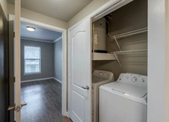 A small laundry room with a washer and dryer.