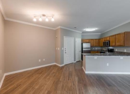 A kitchen with wooden floors and a white countertop.