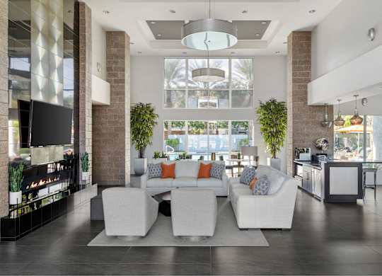 A modern living room with a white couch and a fireplace.