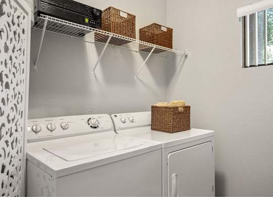 A white washing machine with a basket on top of it.