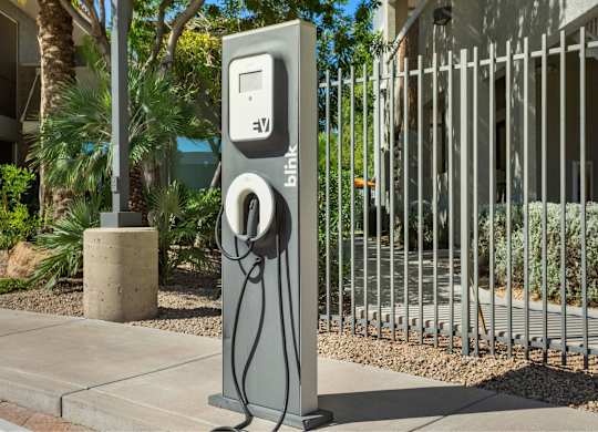 A grey charging station with the word Blink on it.