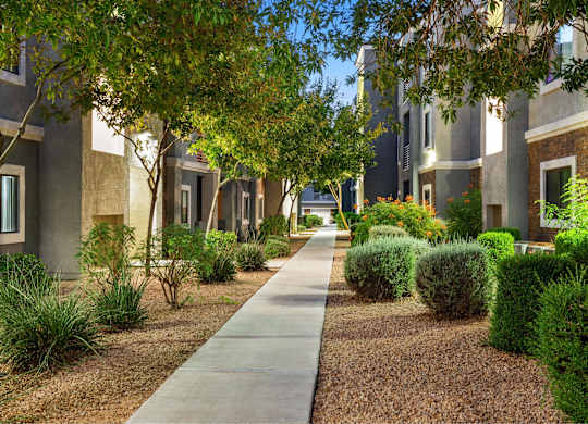 A long concrete walkway leads between two rows of houses.