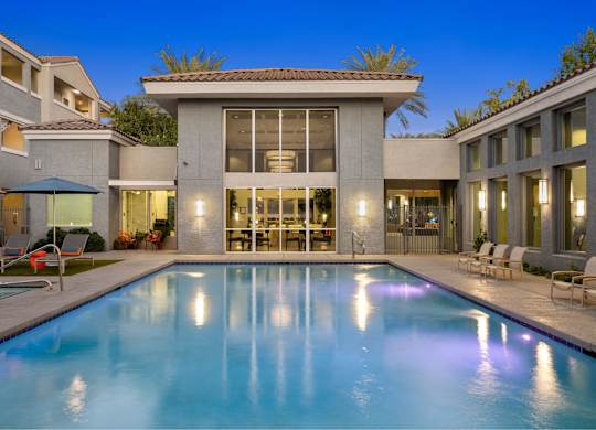 A modern house with a pool in the backyard.