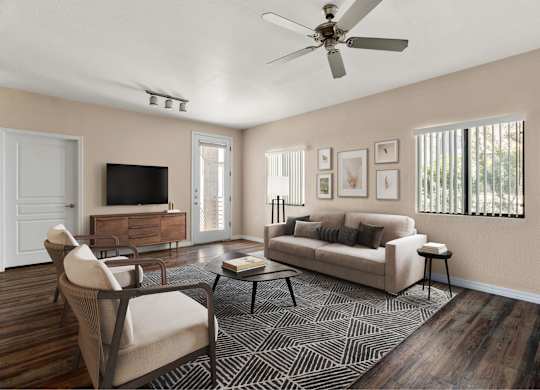 A living room with a couch, chair, and television.