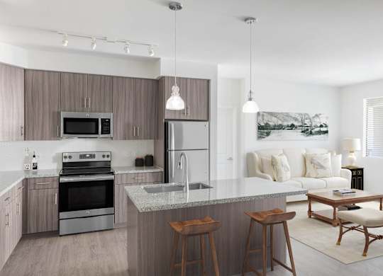 A modern kitchen with a large island and a dining area.