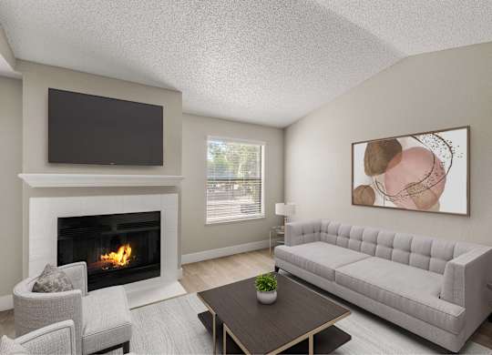 A living room with a fireplace, a grey sofa, a coffee table, and a painting on the wall.