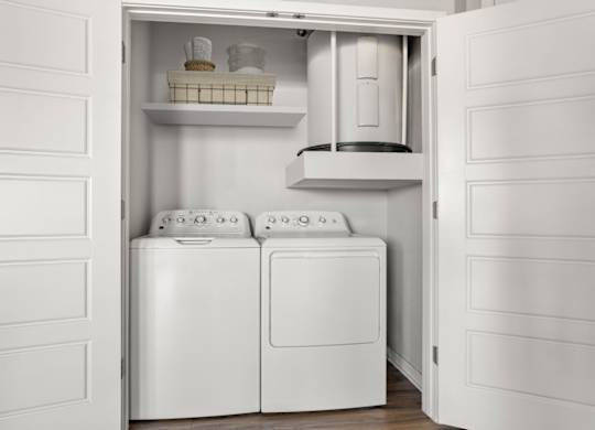 A white laundry room with a washer and dryer in it.