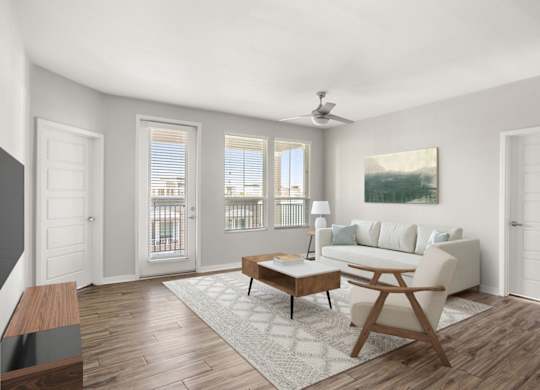 A living room with a white couch, a wooden coffee table, and a painting on the wall.