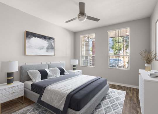 A bedroom with a large bed and a ceiling fan.