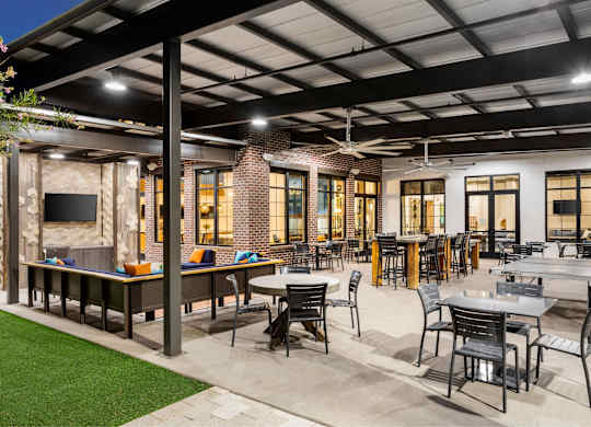 A patio with tables and chairs is set up outside a building.