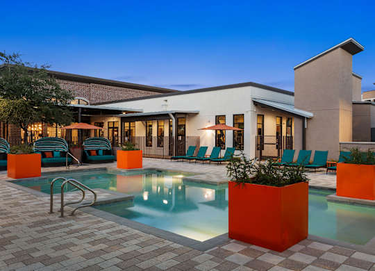 A modern house with a pool in the backyard.