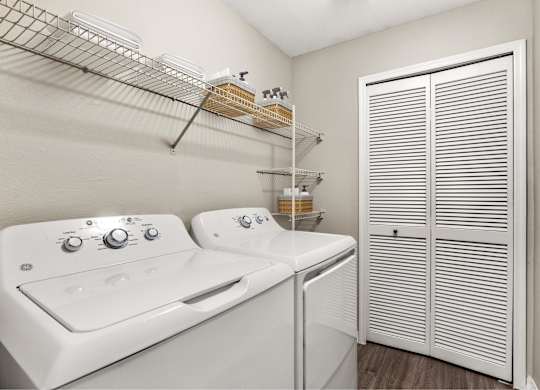 A white washer and dryer in a laundry room.