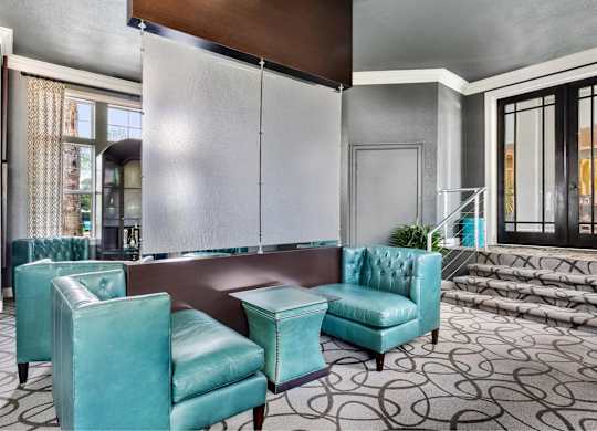 A room with a blue chair and a brown table.