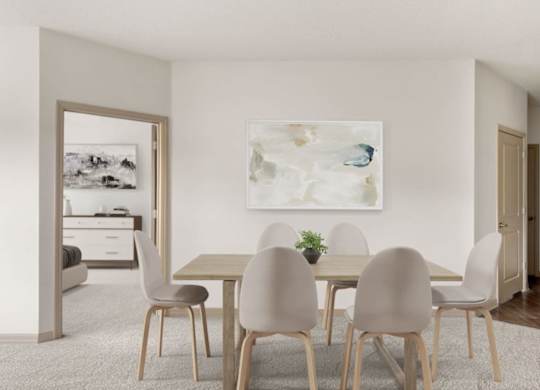 A dining room with a table and chairs.