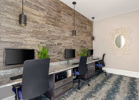 A room with a stone wall and a mirror on the wall.