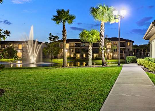 A building with a fountain in front of it.