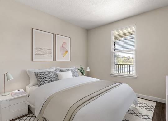 A bedroom with a large bed and a window with blinds.