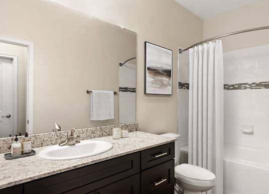 A bathroom with a white toilet and a white shower curtain.