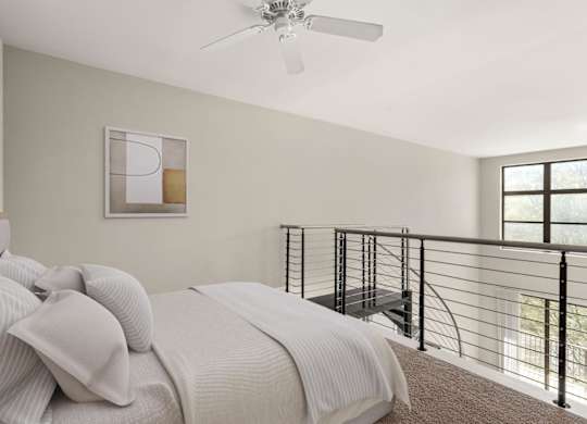 A bedroom with a bed, a ceiling fan, and a balcony.