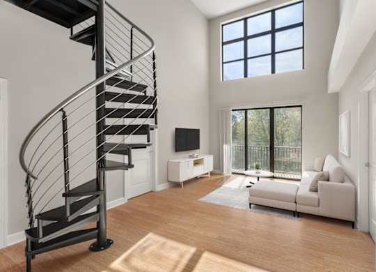 A living room with a spiral staircase and a couch.