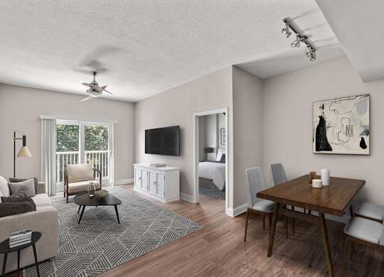 A living room with a television, a couch, a chair, a table, and a painting on the wall.