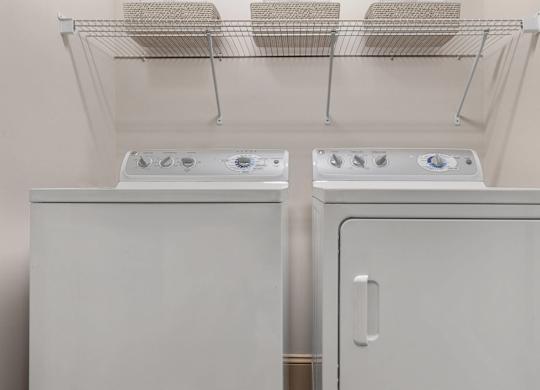Two white ovens are in a kitchen.