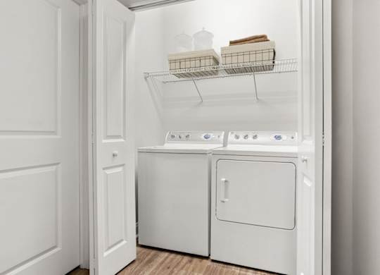 A white laundry room with a washer and dryer.