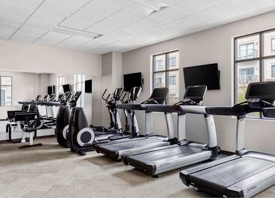 A gym with treadmills and exercise bikes.