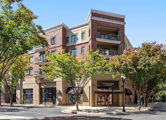 A multi-story building with a branching roofline and a ground floor with a storefront.