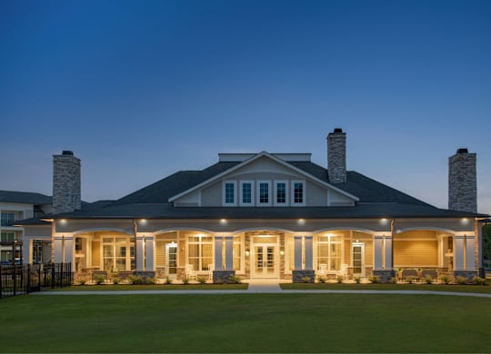 A large house with a front porch and two chimneys.