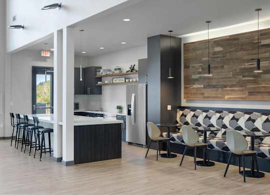 A modern kitchen with a bar area and seating.