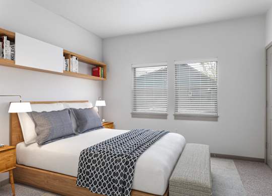 A bedroom with a bed, nightstand, and window with blinds.