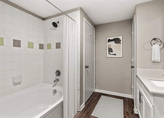 A white bathroom with a white tub and a white sink.
