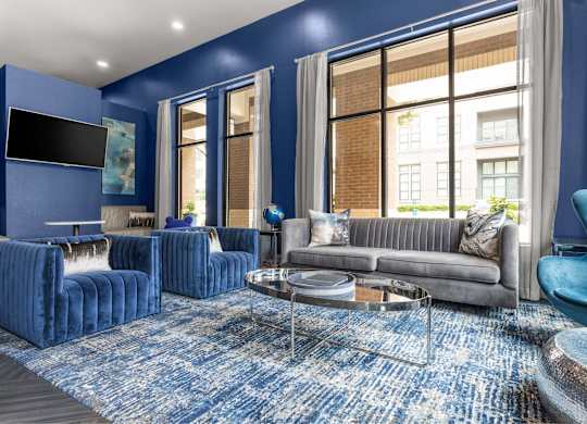 A living room with blue walls and furniture.