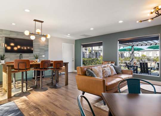 A modern dining room with a wooden table and chairs.