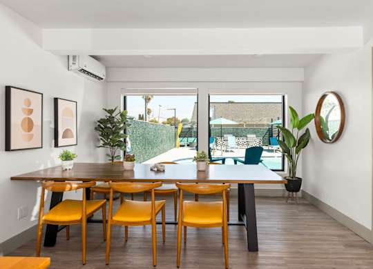 A dining room with a table and chairs.