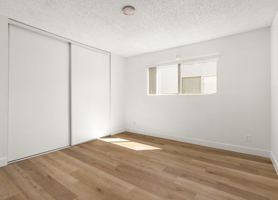 A room with a sliding door and a window.