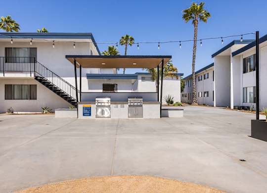 A modern house with a white exterior and a brown door.