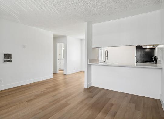 A kitchen area with a counter and a sink.