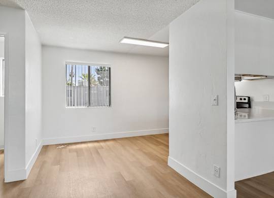 A room with white walls and wooden flooring.
