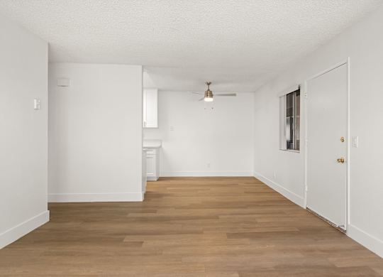 A room with wooden floors and white walls.