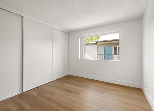 A room with a sliding door and a window.