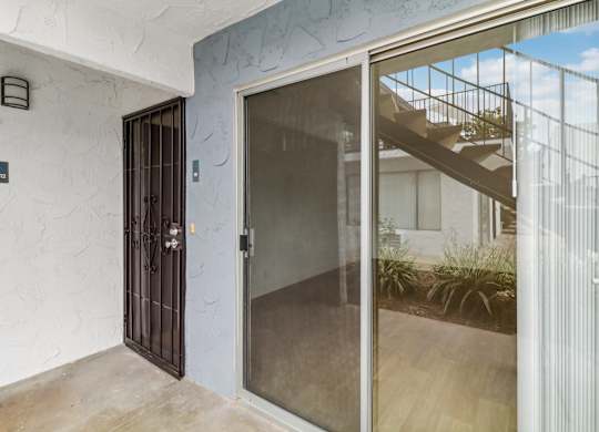 A glass door with a metal handle and a window on the other side.