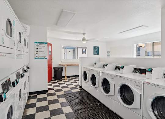 A row of washing machines in a laundromat.