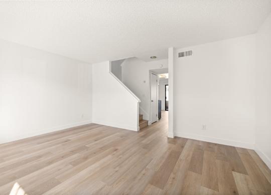 A room with wooden floors and white walls.
