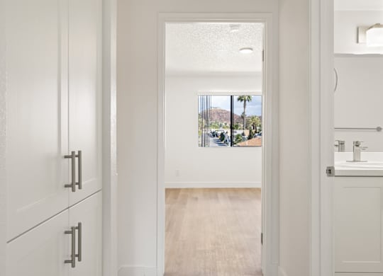 A bathroom with a white sink and cabinet.